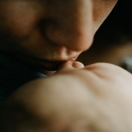 woman kissing baby
